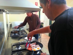 Graham and Mal cooking breakfast in the camp kitchen
