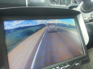 Mal sits on 100km per hour on cruise control, but we are about to be overtaken by a huge road train. 